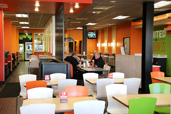 Cicis remodeled dining room now includes regular and bar-height seating with dividers.