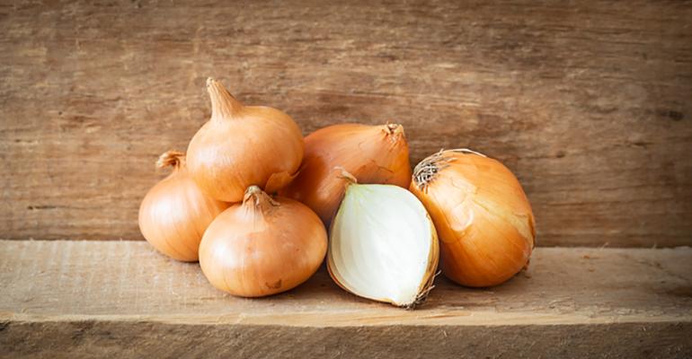 Onions on a board, with one cut in half