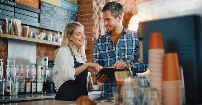 Smiling employees in a cafe setting