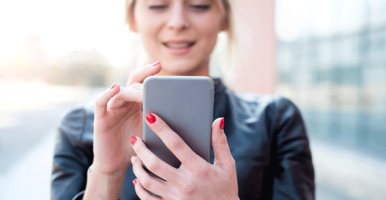 Woman looking at cell phone.png