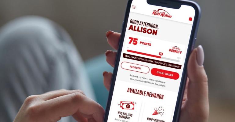 A person holding their phone looking at the Red Robin loyalty app