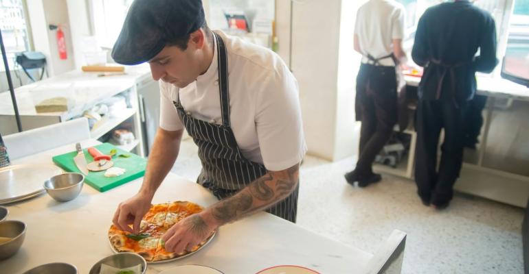 A restaurant employee making food