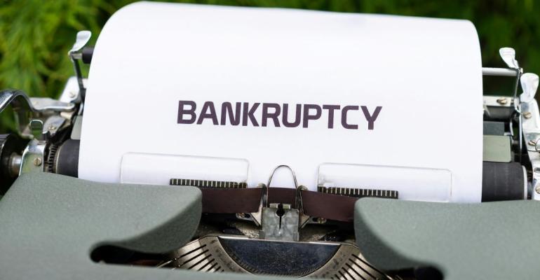 paper that says "bankruptcy" in a typewriter