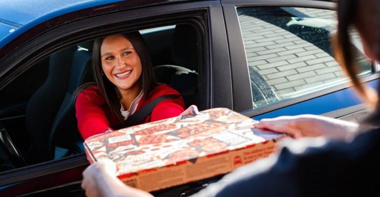 Pizza Hut drive-through, customer in car receiving pizza