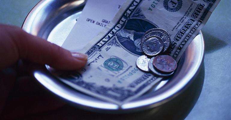 tip bowl with a dollar and some coins