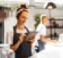 Restaurant worker smiling while holding tablet