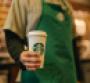 Starbucks employee holding a drink