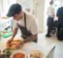 A restaurant employee making food