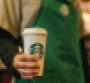 A Starbucks barista holding a cup