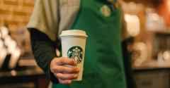 Starbucks barista holding a drink