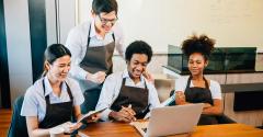 Restaurant employees smiling in a group