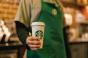 Starbucks barista holding a drink