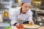 Female chef making a pizza